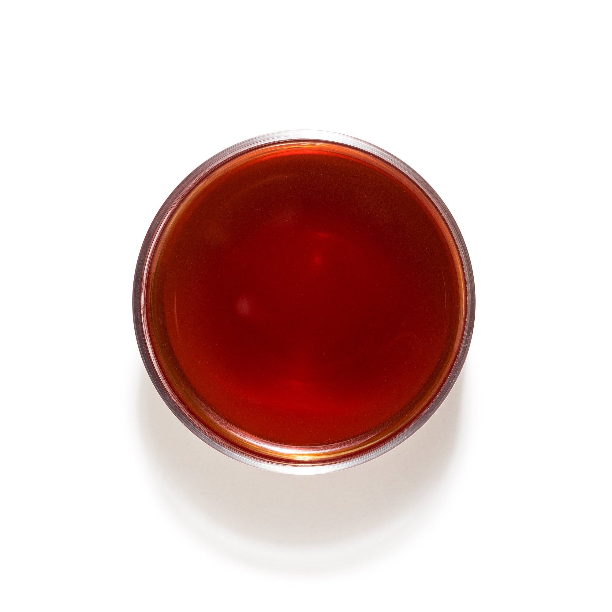 Clover Energy Yerba Mate + Rhodiola brewed tea in a glass mug, adaptogenic herbs